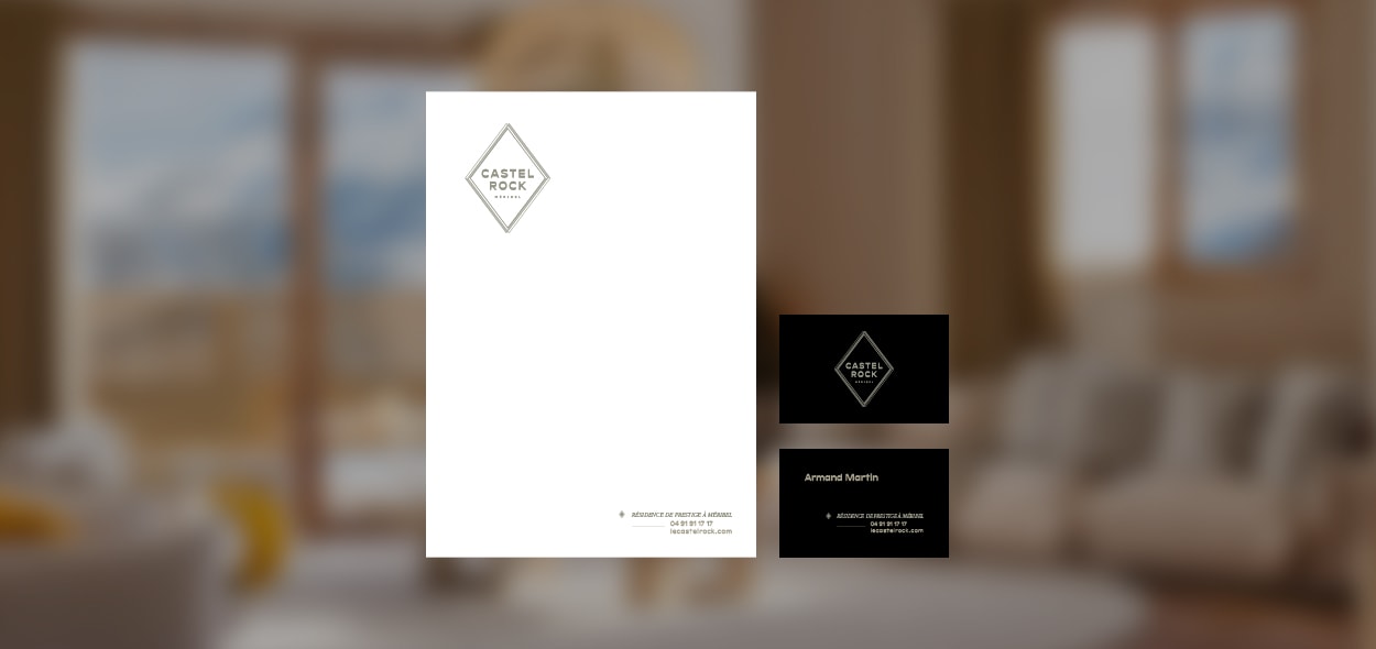 Stationery design of letterhead and business cards for the company Anders on top of a blurred photo of a house interior.
